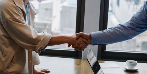 Two people shaking hands at a job interview