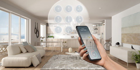 A person holding a smartphone about to control his/her living space