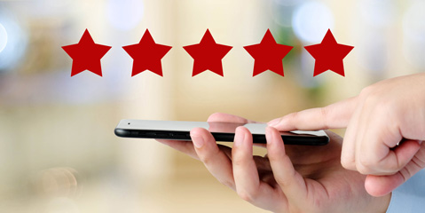 A person using his/her smartphone to provide an online review